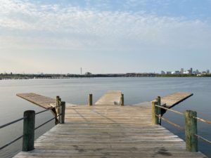 Pier and water at Middle Branch park with the Baltimore skyline in the distance.