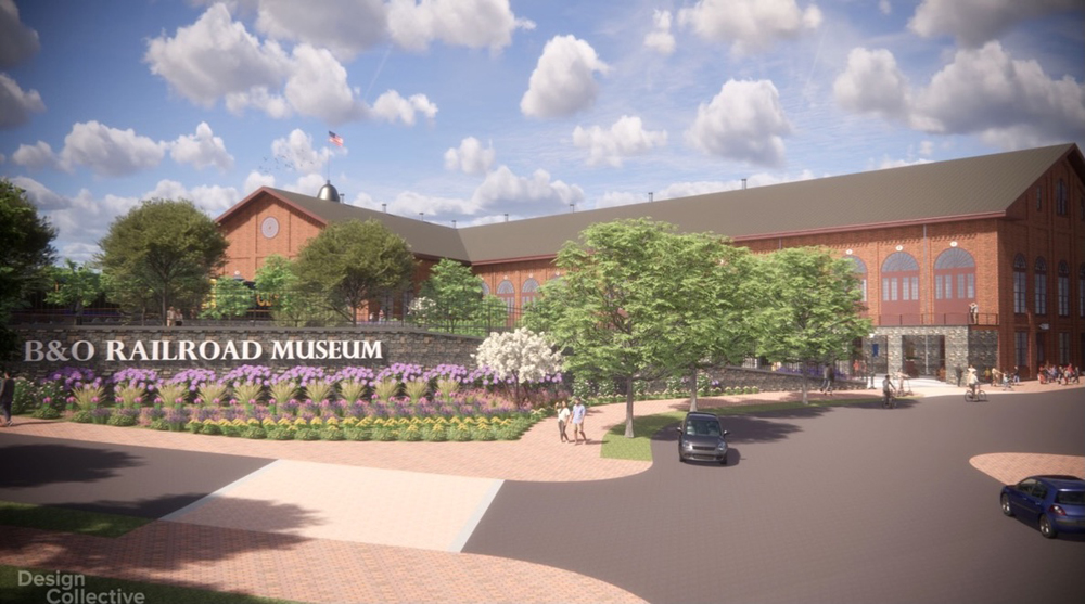 Design rendering of the future B&O entrance and South Car building which has a wide, curved entry way and a B&O Museum sign surrounded by trees and flowering shrubs.